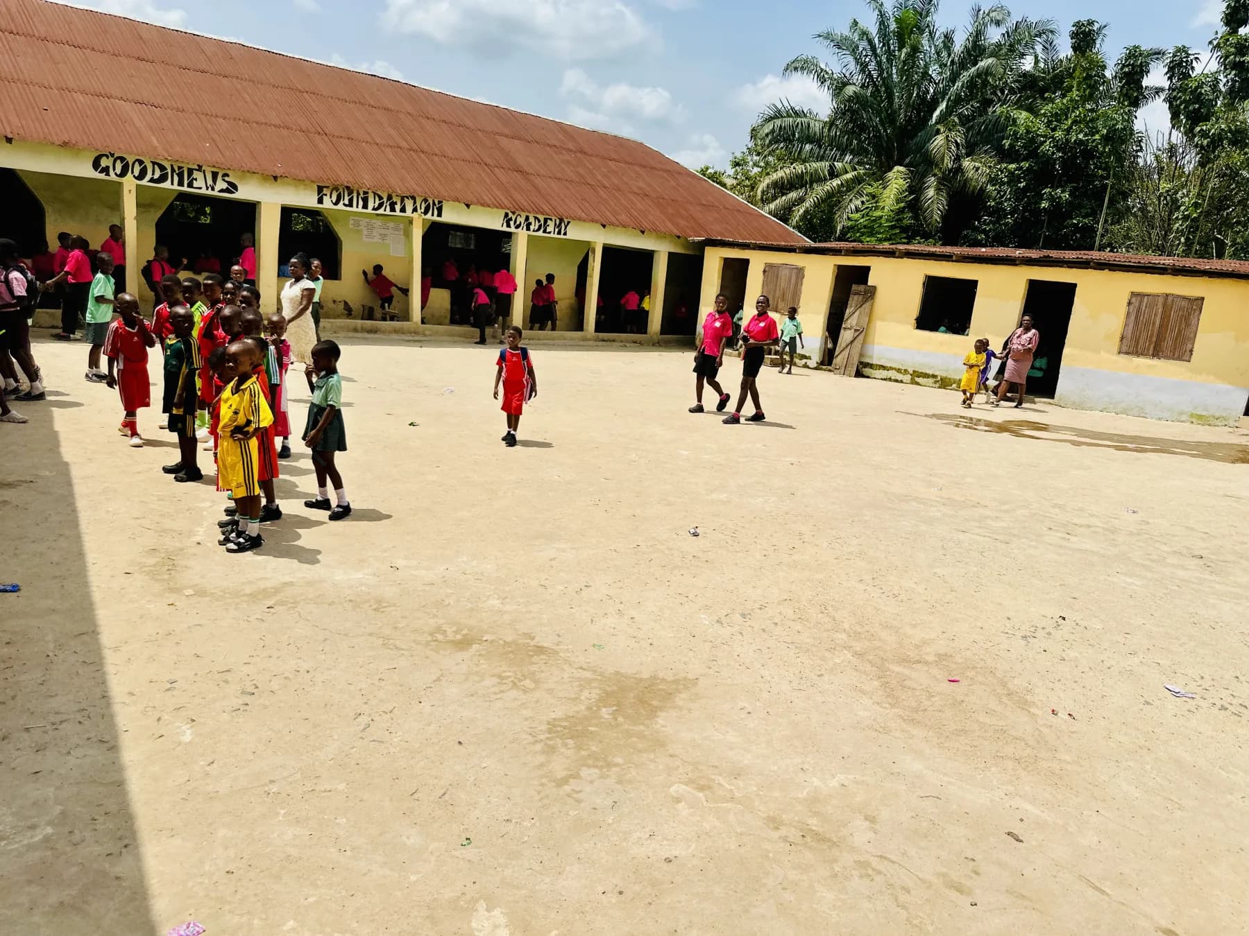 Pupils and teachers in the Goodnews Foundation Academy courtyard