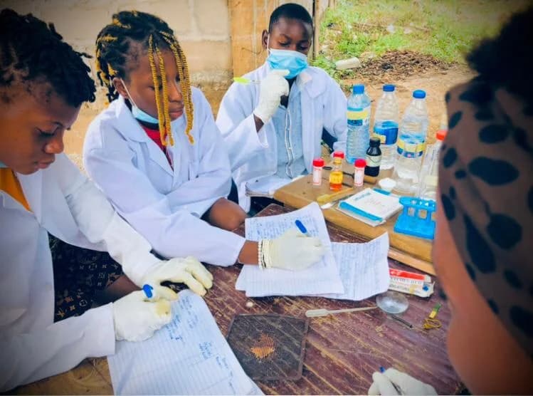 Students recording observations during an experiment